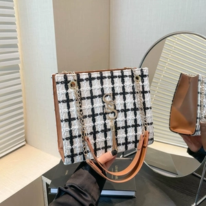 Chic black and white checkered tweed tote bag with gold chain and logo mirror detail