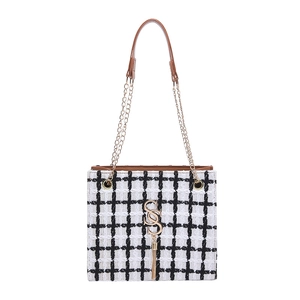 Checkered tweed tote bag with brown leather trim and dual chain straps for winter fashion