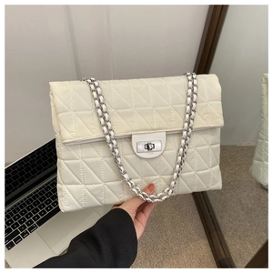 Detail of white quilted nylon bag with silver chain strap and metal twist lock closure