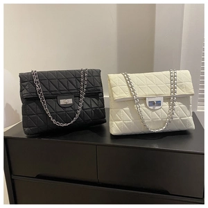Quilted flap chain bags in black and cream featuring silver-tone metal twist lock closure