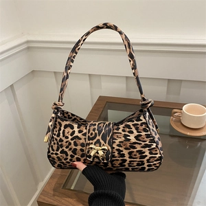 Fashionable leopard print shoulder bag with gold bow clasp and stylish knot strap