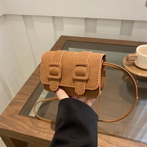 Minimalist brown croc-embossed flap crossbody bag with double buckle straps