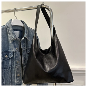 Detail of the black synthetic leather hobo bag with textured surface and spacious interior