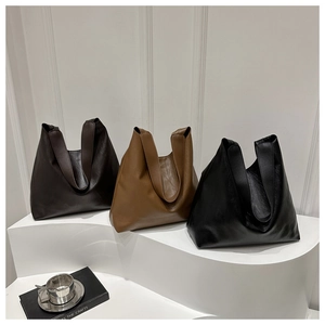 Three minimalist faux leather tote bags in dark coffee, camel, and black colors