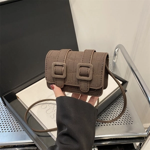 Brown mini crossbody bag with crocodile embossing and dual buckle closure