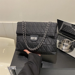 Large black quilted crossbody bag with diamond stitching and silver chain strap for work