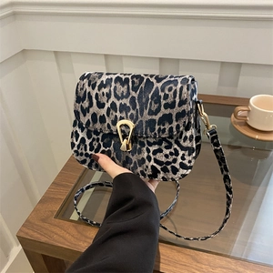 Leopard print crossbody bag with gold horseshoe buckle and adjustable strap for women