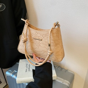 Elegant cream underarm bag with floral lace embroidery and knotted rope straps