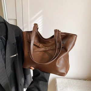 Deep brown large tote bag with textured leather and long shoulder straps in a retro style