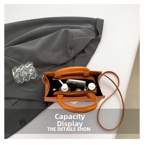 Interior view of orange crocodile texture handbag showing compartments and storage capacity