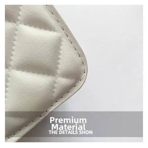Detailed close-up of premium white quilted leather texture with precise diamond stitching