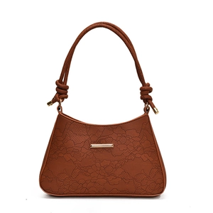 Elegant dark brown leather tote bag with floral lace embossing and gold metal hardware