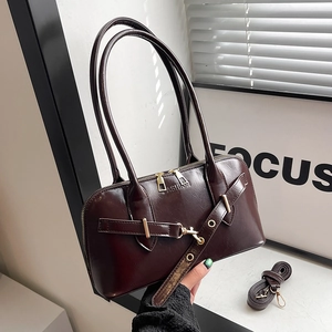 Retro dark brown leather bowling bag with gold buckle and adjustable shoulder strap