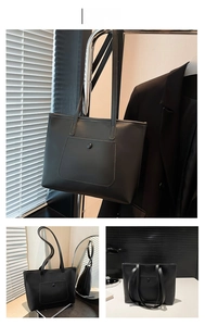 Dettaglio borsa tote minimalista in pelle nera con tasca frontale e tracolle lunghe sottili