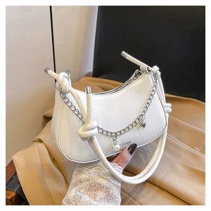 Detail of cream crescent bag with silver chain, pearl pendant and knotted handle