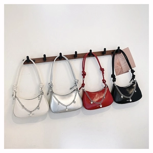 Detail of crescent shoulder bags in four colors with pearl chains and knotted straps