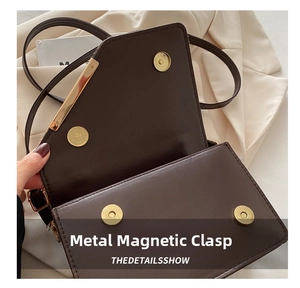 Close-up of golden magnetic hardware clasp on a premium brown textured leather bag