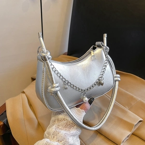 Silver metallic crescent moon bag with chain charms and trendy knotted handle for women