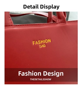 Detail of red leather tote bag with yellow Fashion Bag text and precise stitching
