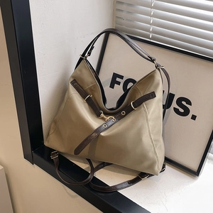 Olive green large capacity tote bag with brown leather straps and gold buckles