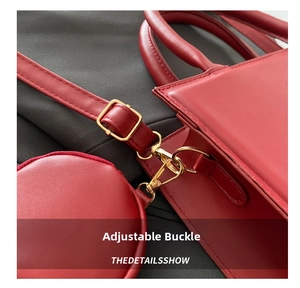 Macro detail of red leather bag showing golden adjustable buckle and round coin pouch