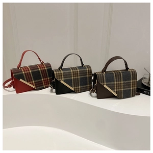 Three vintage plaid crossbody bags in red, black, and brown with gold metal trim