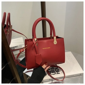 Detail of red leather handbag with gold buckle and Fashion & Bags gold lettering