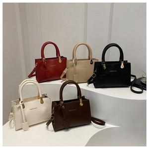 Detailed collection of vintage top-handle handbags in red, beige, black, and brown