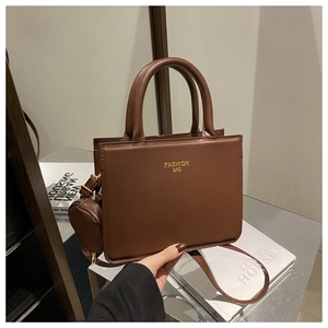 Close-up of deep brown leather square tote with small coin purse and top handles