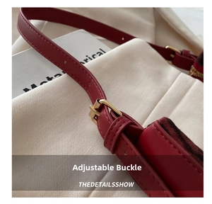 Close-up of red leather strap with adjustable gold buckle and precise stitching