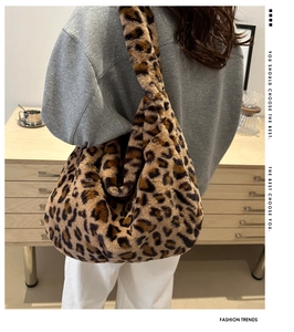 Detail of soft leopard print plush tote bag showing oversized fit and fluffy texture