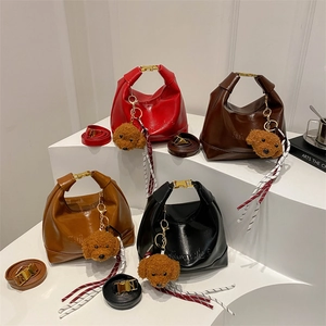 Fashionable large crescent hobo bags in four colors with plush charms and shoulder straps