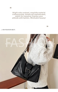 Detail of black leather tote bag featuring silver side zippers and buckle closure