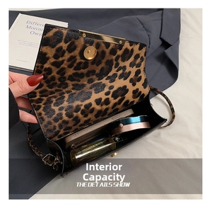 Detail view showing internal storage space for essentials in leopard print crossbody bag