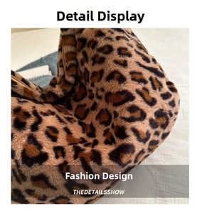 Close-up of leopard print plush faux fur fabric with premium gold zipper detail