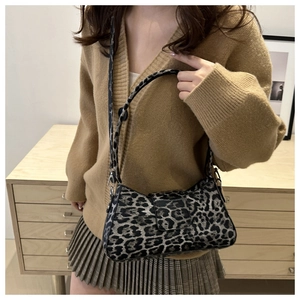 Close-up of leopard print shoulder bag worn by model in stylish autumn knitwear