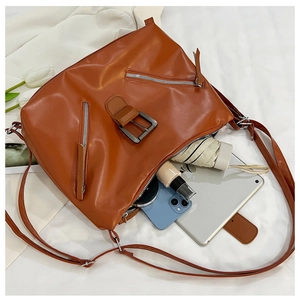 Detailed interior of caramel tote bag showing capacity for tablet, phone and umbrella
