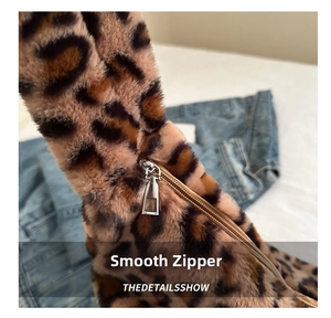 Close-up of smooth metal zipper on stylish faux fur leopard print tote bag fabric