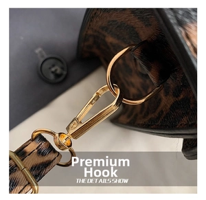 Detailed macro shot of high-quality gold metallic hook and strap on leopard print bag