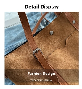 Detail view of brown matte suede tote bag with silver buckle and fine stitching