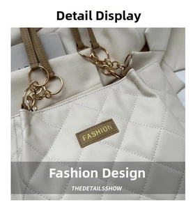 Detail of off-white quilted tote bag featuring golden chain and FASHION label patch