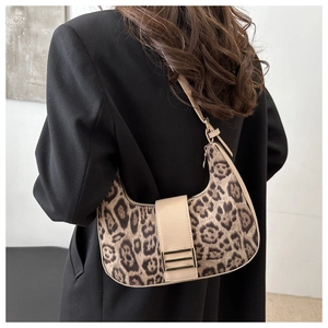 Close-up of leopard print crescent bag with leather strap and gold buckle detail