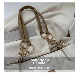 Detailed close-up of ivory quilted tote bag with elegant metal chain handle