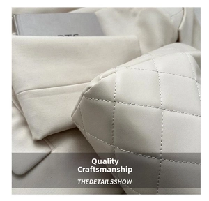 Detailed close-up of quilted ivory leather tote bag featuring elegant diamond stitching
