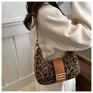 Detail of leopard print shoulder bag with gold metal buckle and brown leather strap
