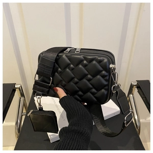 Black quilted crossbody bag detail with wide woven strap and detachable coin purse pouch