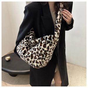 Detailed texture of leopard print faux fur shoulder bag worn with a black blazer
