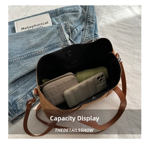 Internal view of brown tote bag showing capacity for wallet, umbrella and phone
