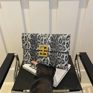 Leopard print envelope clutch with luxury gold geometric buckle and textured finish
