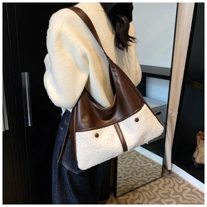 Hobo tote bag in contrast faux leather and white shearling shown on model's shoulder